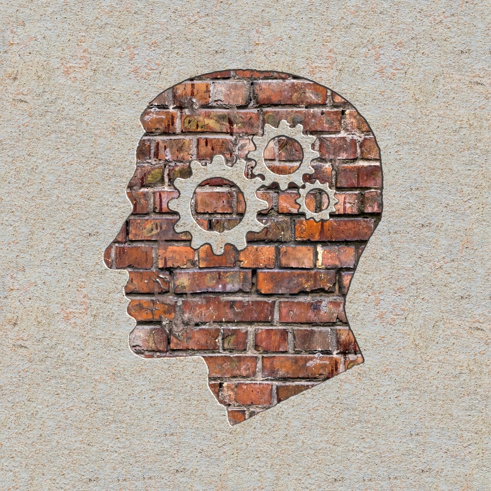 Psychological Concept - Profile of Head with Cogwheel Gear Mechanism on the Brick and Plastered Wall.