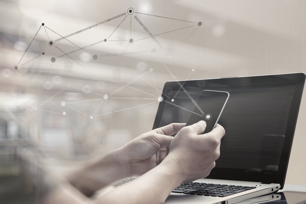 double exposure of young designer working with smart phone and computer in bed as concept